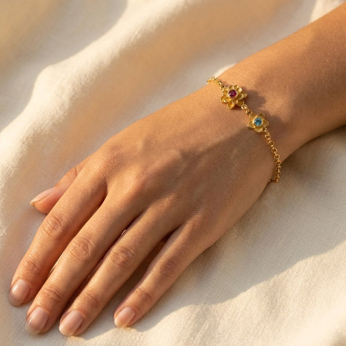 birthstone bracelet for mom featuring multiple kids birthstones in our signature Bloom flower-inspired design shown on wrist for elegant everyday wear meaningful personalized family jewelry crafted in silver gold filled or rose gold filled thoughtful gift for mom grandma or new mom perfect for Mother’s Day birthdays and anniversaries adjustable chain comfortable fit feminine floral birthstone setting celebrating connection between mother and children