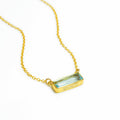 Single gold filled cable chain with horizontal blue topaz december birthstone adira bar necklace with secret message engraved on the bottom in modern thin font on white background