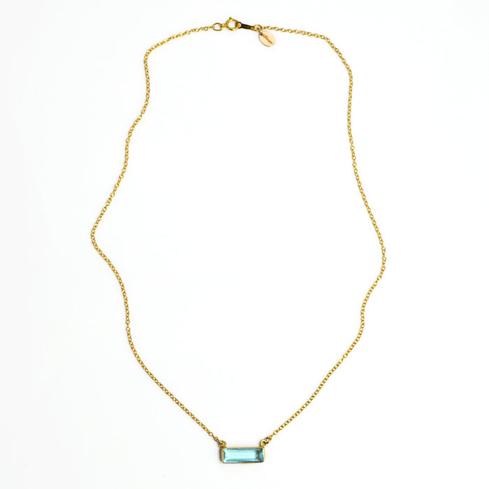Single gold filled cable chain with horizontal blue topaz december birthstone adira bar necklace with secret message engraved on the top in typewriter font on white background