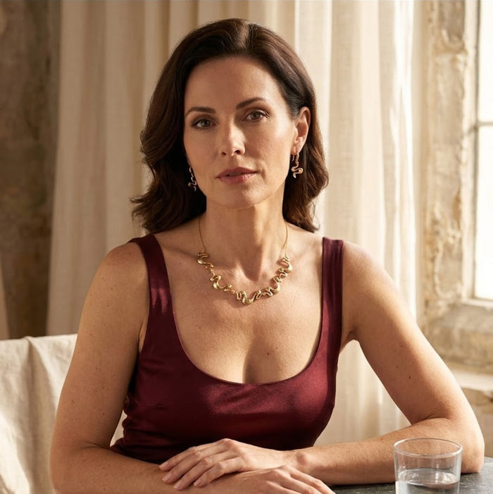 Model wearing gold boho wave necklace with matching earrings styled as modern statement jewelry