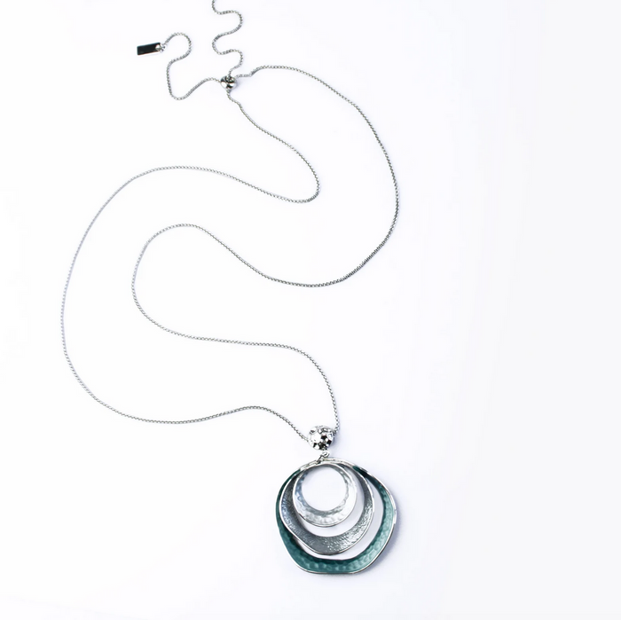 beautiful three-ring circles statement necklace with silver and blue tones on white background boho bohemian