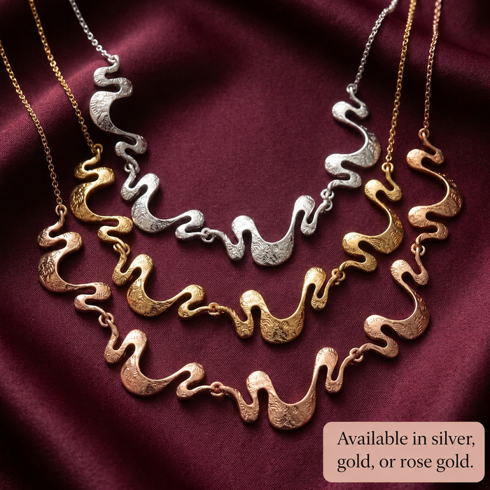Gold silver and rose gold boho wave necklace options with matching earrings on burgundy fabric