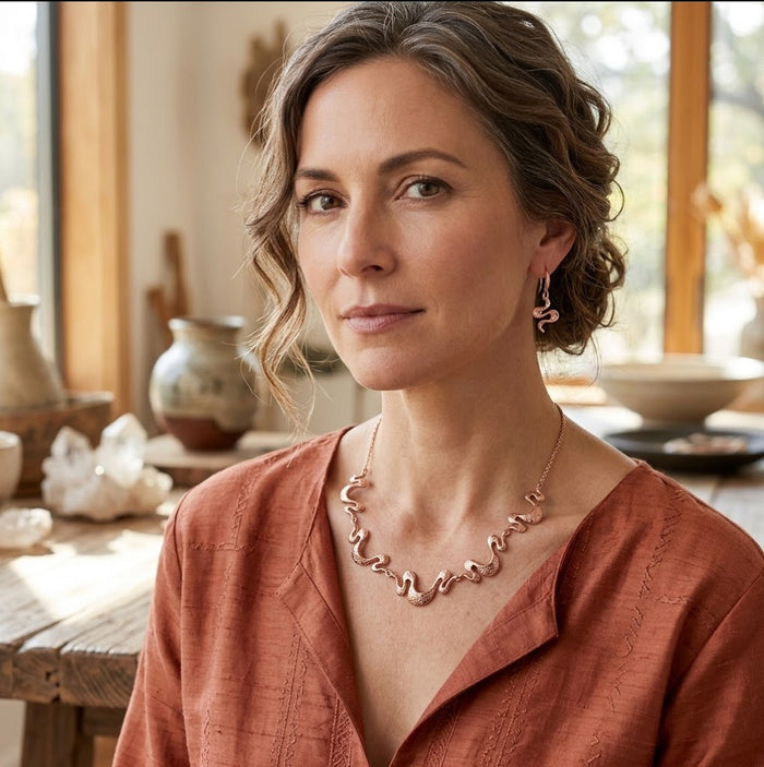 Model wearing rose gold wave necklace and earrings from the boho statement jewelry set