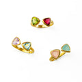 Three triangle bow tie rings with mix and matched birthstones. Custom birthstone ring, adjustable triangle ring, bow tie gemstone ring, personalized jewelry, double triangle ring, mix-and-match birthstones, sterling silver bow tie ring, gold bow tie ring, rose gold bow tie ring, unique birthstone gift, triangle-cut gemstone ring, customizable birthstone jewelry, adjustable band ring, personalized triangle ring, birthstone stacking ring, custom gemstone jewelry, unique gift for her, triangle gemstone ring
