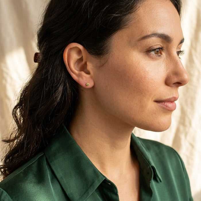 Model wearing tiny custom birthstone stud earrings, a minimalist personalized gemstone earring gift for birthdays, bridesmaids, moms, sisters, or friends.