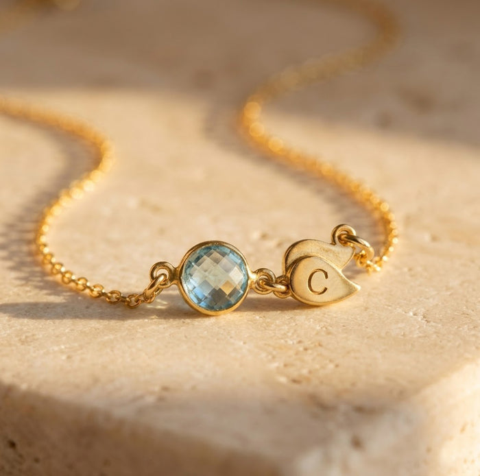 Minimalist gold necklace with single birthstone and initial pendant