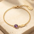 Custom birthstone name bracelet with one purple birthstone and engraved Katy name charm on gold chain.