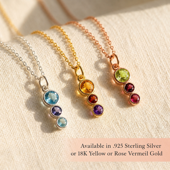 Birthstone necklaces in sterling silver, yellow gold, and rose gold displayed in warm light, showing colorful family gemstone combinations for mom and kids.