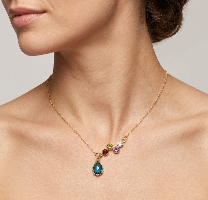 Woman wearing personalized family birthstone necklace for mom with teardrop pendant