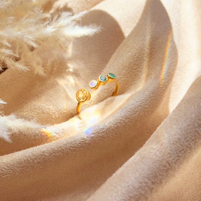 Handcrafted adjustable birthstone ring for a mom of three children, showing one large 5mm bezel-set center stone and three smaller 3mm child birthstones in a vibrant multi-colored arrangement. Designed in gold vermeil with smooth, comfortable edges for daily wear. Ideal personalized jewelry gift for Mother’s Day, birthdays, and holidays, offering a meaningful way for moms to keep their children close through custom family jewelry.