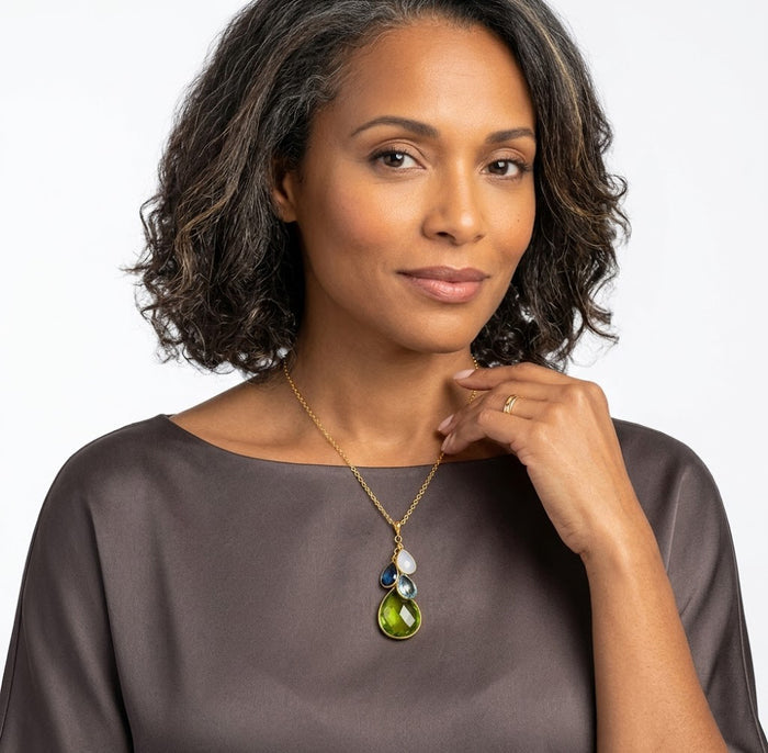 Model wearing custom birthstone necklace for mom with natural gemstones, a meaningful family jewelry gift in gold.