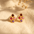 Custom four birthstone stud earrings with natural 3mm gemstones in yellow gold vermeil on warm beige fabric