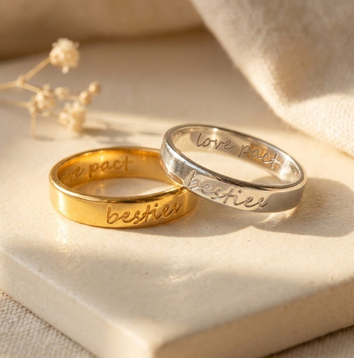 Custom handwriting engraved rings in gold and sterling silver with names and meaningful phrases on 4mm bands.