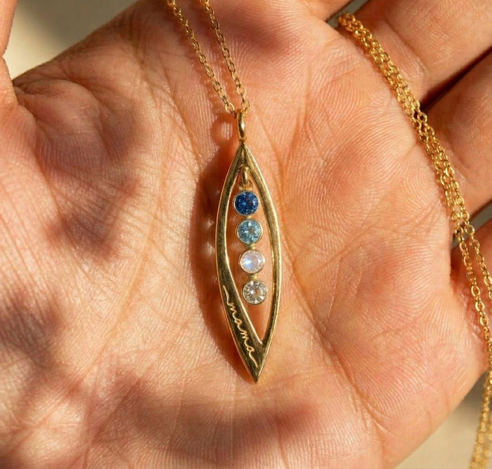 Hand holding custom marquise pendant necklace with multiple birthstones, personalized jewelry gift for mom