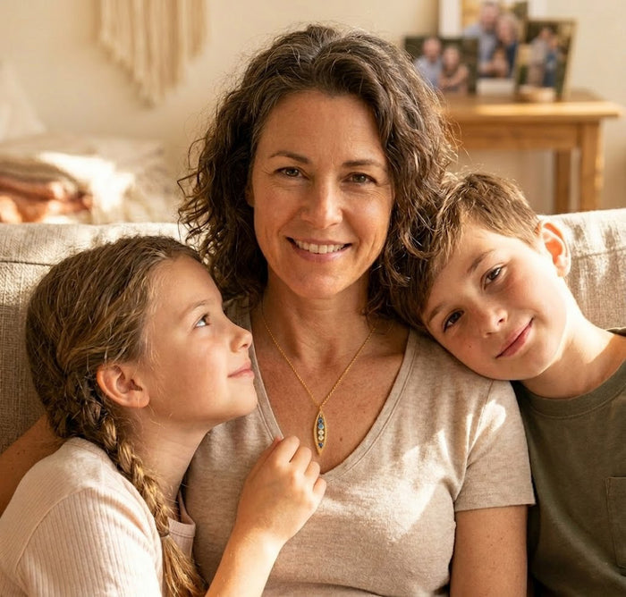 Mom wearing mothers' necklace with tiny birthstones representing her kids in gold