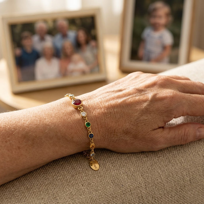 Hand holding personalized birthstone bracelet for grandma with grandkids birthstones and initials, thoughtful Mother’s Day gift symbolizing motherhood and love