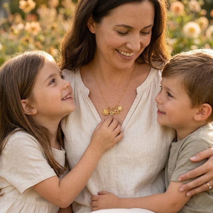 Mother and children wearing custom birthstone flower necklace, meaningful family jewelry gift with personalized flower charms.