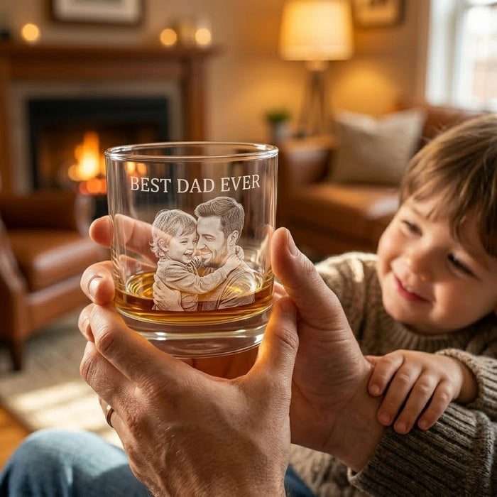 Personalized whiskey glass held in hand with engraved family photo and Father’s Day design.