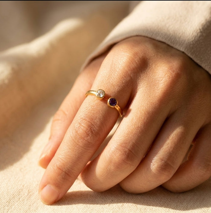 Woman wearing a dainty adjustable birthstone ring with two natural gemstones, elegant stacking ring for everyday wear and personalized jewelry styling