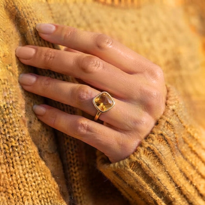 Model wearing a dainty gold vermeil citrine birthstone ring