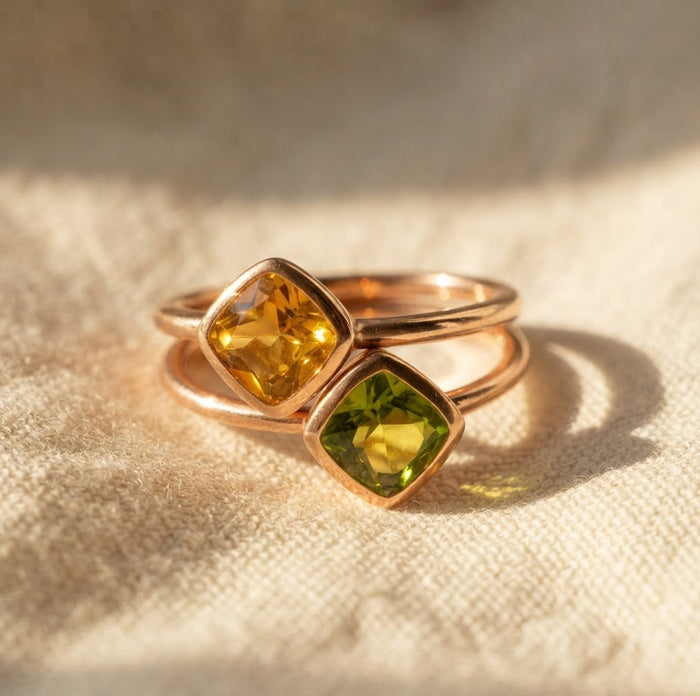 Citrine and peridot gemstone rings stacked together in gold vermeil