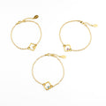 Three adjustable gold filled geometric square bracelets from top with citrine, purple amethyst, and kyanite birthstones on a white background.