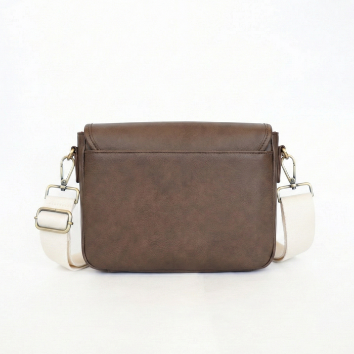 Brown leather crossbody bag with white accents on a white background