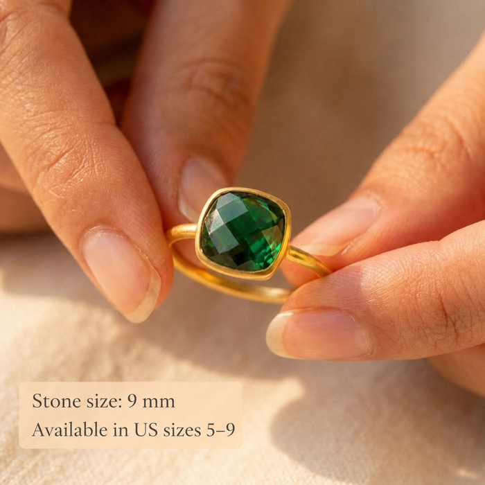 Close-up of emerald quartz cushion ring held between fingers with text showing 9mm stone size and US ring sizes 5–9.