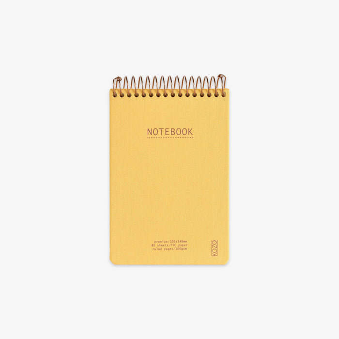 Yellow notebook with spiral binding on a white background