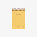 Yellow notebook with spiral binding on a white background