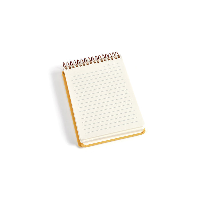 Small spiral-bound notebook with lined pages on a white background