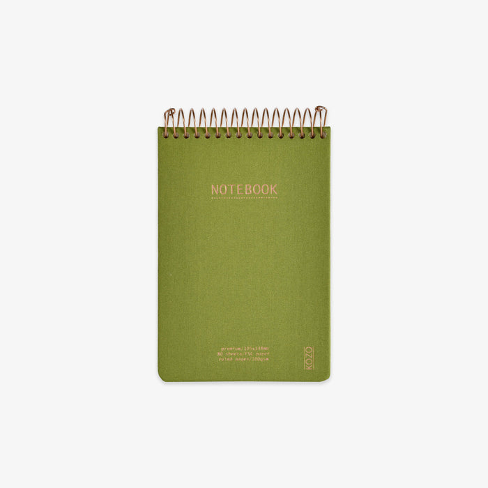 Green notebook with spiral binding on a white background