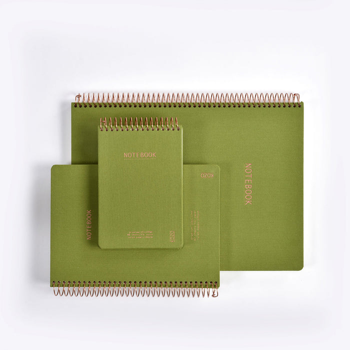 Set of green spiral-bound notebooks on a white background