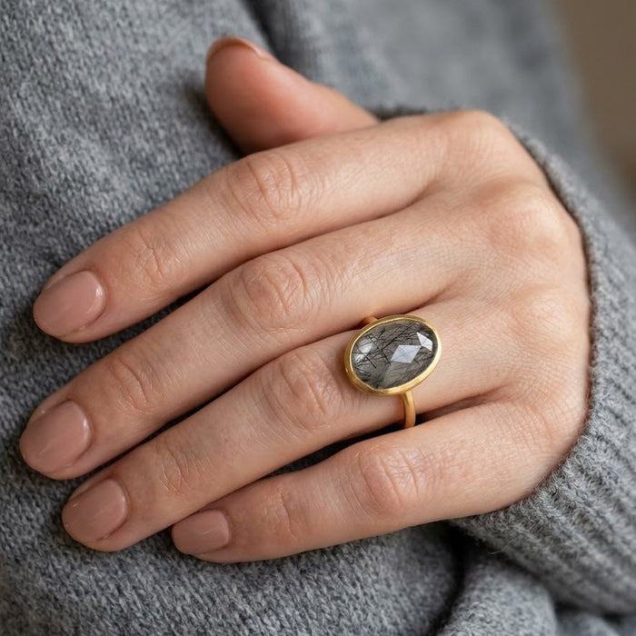 Large black rutilated quartz teardrop ring in yellow gold vermeil worn on hand