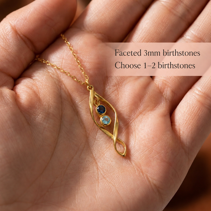 Personalized necklace held in hand with faceted 3mm birthstones and custom choice of 1 or 2 children’s birthstones.