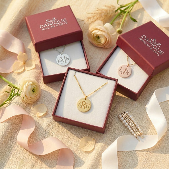 Gift-ready monogram necklaces displayed in Danique Jewelry boxes, featuring personalized initial pendants for birthdays, weddings, or bridesmaid gifts.