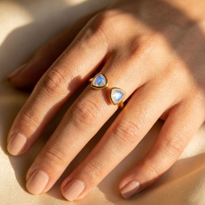Moonstone triangle adjustable ring worn on hand, showing the open band and dainty gemstone size.