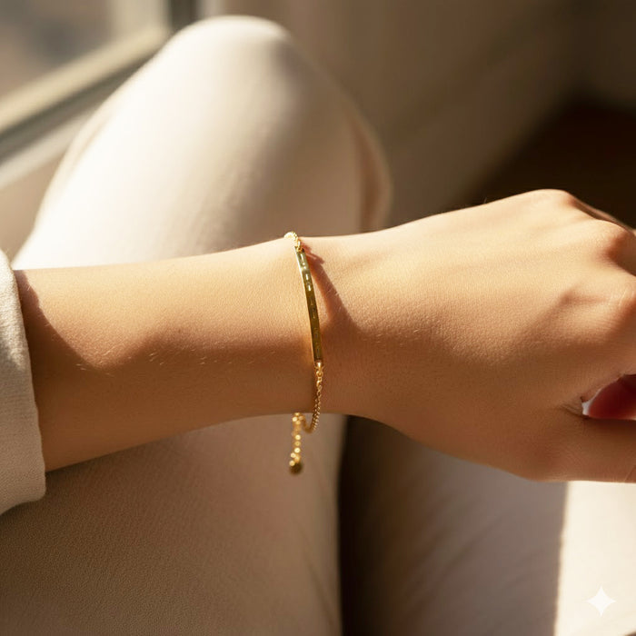 Dainty gold Morse code skinny bar bracelet on woman’s wrist, slim polished bar engraved with tiny dots and dashes for a hidden message, minimalist personalized bar bracelet with delicate adjustable chain and extender, available in .925 sterling silver, 14k yellow or rose gold filled, elegant everyday jewelry that layers perfectly with other stacking bracelets, thoughtful custom gift for mom, sister, best friend or girlfriend for birthday, anniversary, graduation or Christmas.