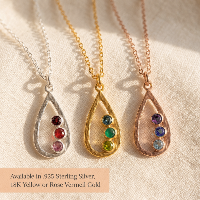 Three open teardrop birthstone necklaces in sterling silver, yellow gold vermeil, and rose gold vermeil with colorful gemstones.