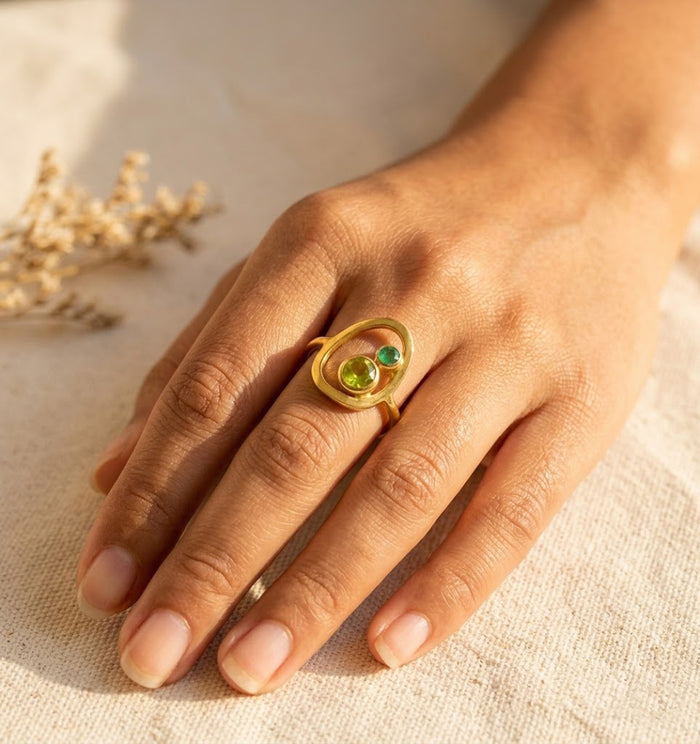 Mother and child birthstone ring worn on hand with two custom birthstones representing mom and child.