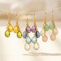 Custom mother’s birthstone earrings featuring teardrop gemstones personalized to represent children or grandchildren, handcrafted in sterling silver or gold filled metal as meaningful family jewelry for Mother’s Day or birthdays.