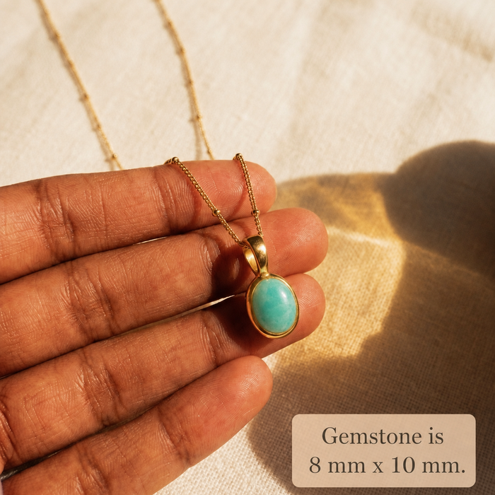 Amazonite oval cabochon necklace shown in hand with 8 x 10 mm gemstone size note.