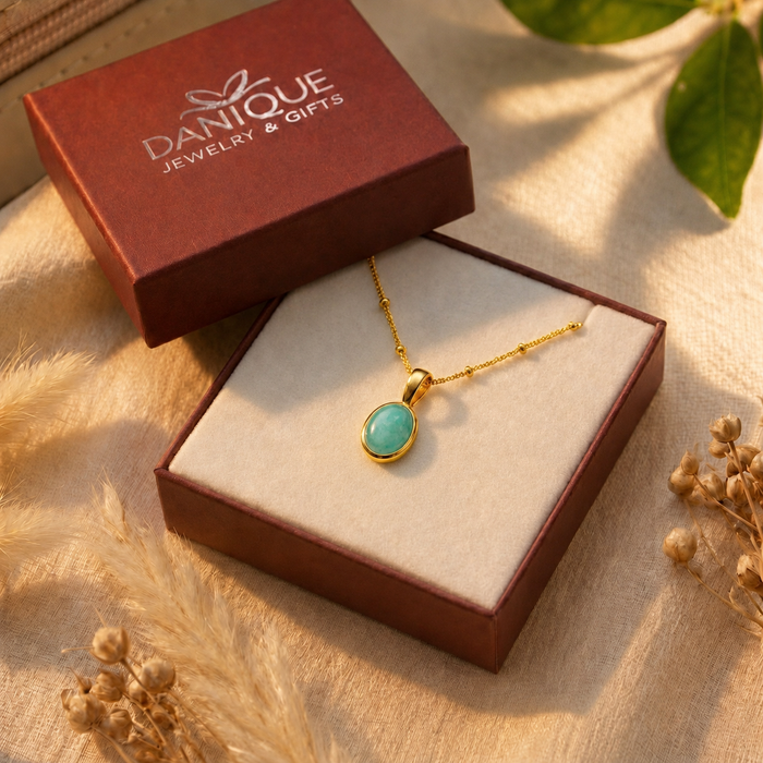 Amazonite oval necklace in hand with note about natural stone color and pattern variation.