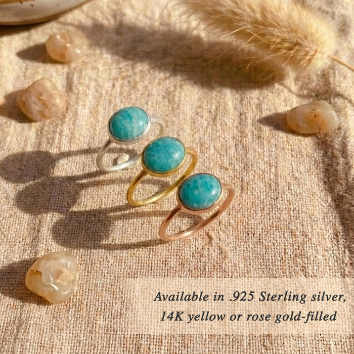 Amazonite rings displayed together showing oval cabochon stones set in minimalist gold and sterling silver bands. Turquoise blue gemstone rings crafted for everyday wear, layering, and modern jewelry styling. Ideal gift for her or birthstone-inspired jewelry.