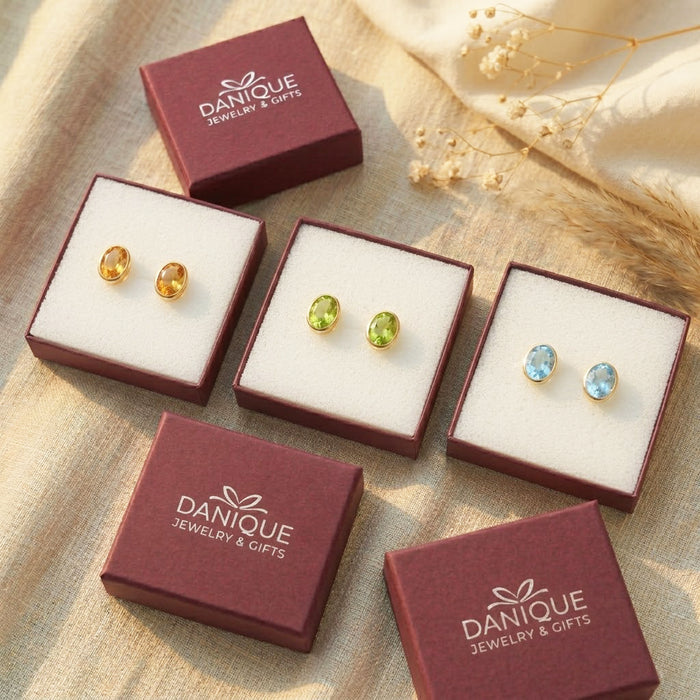 Danique Jewelry gift boxes with oval birthstone stud earrings, showing gift-ready packaging and gemstone color options.