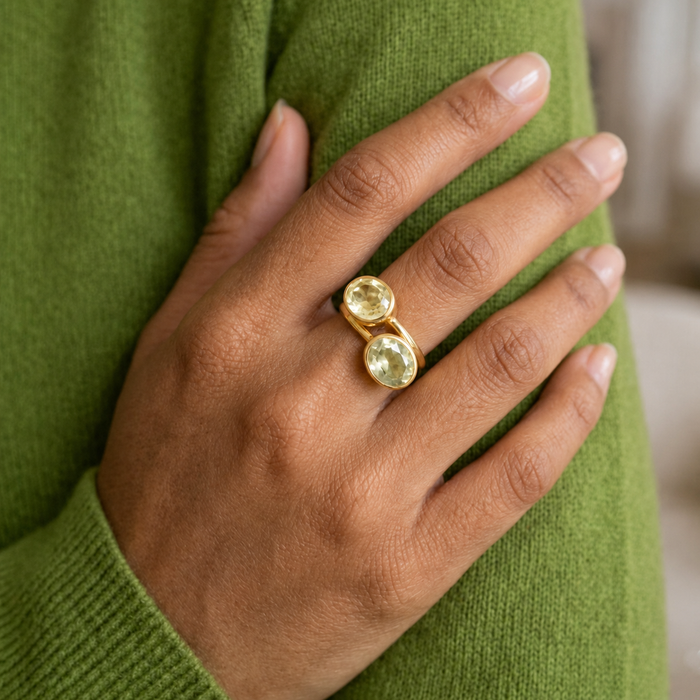 Model wearing a lemon quartz ring paired with a green gemstone ring, showing stacking and gemstone pairing inspiration.