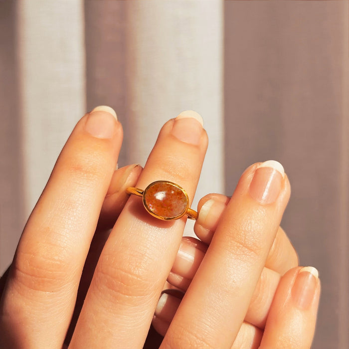 Model placing a  Shimmering Sunstone cabochon ring on hand. 18K Vermeil Gold Sunstone Oval Ring, Summer Jewelry, Celestial Sun Jewelry, Sparkling Gemstone, Sunstone Oval Solitaire Ring, Dainty Gold Stacking Ring Gift for Her
