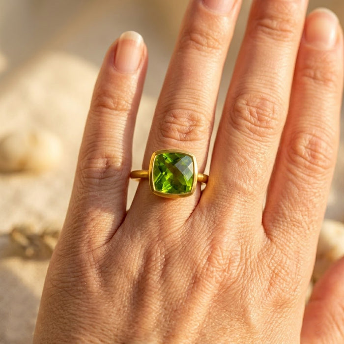 Cushion peridot rings in gold, silver and rose gold bezel settings