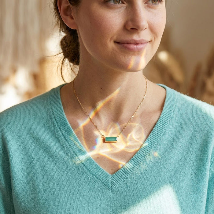 Model wearing a dainty aqua chalcedony baguette bar necklace with a delicate gold chain.