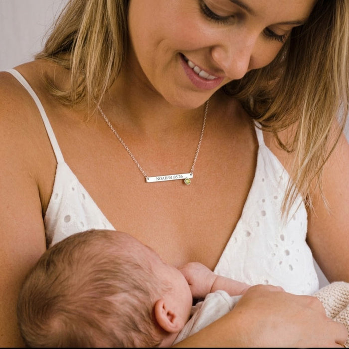 Mother wearing personalized birthstone bar necklace with engraving as a meaningful new mom gift